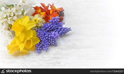 pretty spring flowers picked from garden and arranged on a table in romantic effect . pretty spring flowers picked from garden and arranged on a table