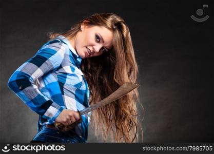 Pretty strong woman holding machete.. Pretty gorgeous woman holding machete. Strong girl feminist wearing checked shirt.