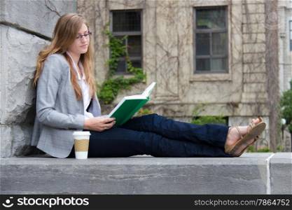 Pretty student quietly reading a book