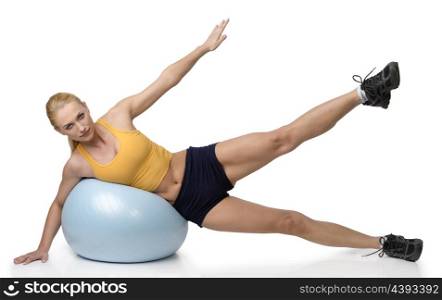 pretty stunning girl on a big fitness ball doing stretching exercises for her body