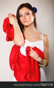 Pretty summer woman fashionable girl in white dress with red shawl on gray background. Fashion photo