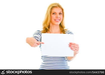 Pretty teen girl pointing on blank paper sheet isolated on white &#xA;