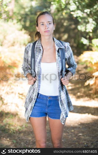 pretty teen hiking in the forest