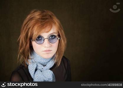 Pretty teenage girl with round blue sunglasses