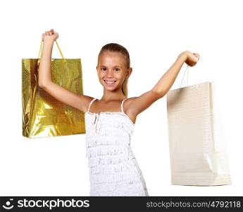 Pretty teenage girl with shopping bags in studio against white background