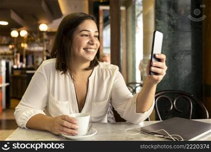 pretty teenager browsing her mobile phone