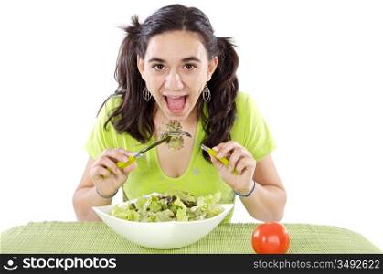 Pretty teenager eating salad over white background
