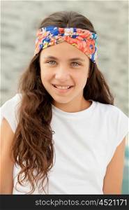 Pretty teenager girl with a flowered headband outdoor