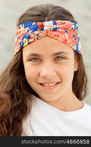 Pretty teenager girl with a flowered headband smiling