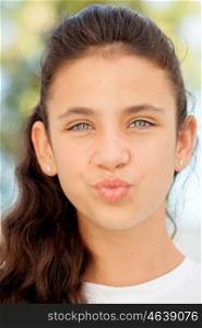 Pretty teenager girl with blue eyes throwing a kiss