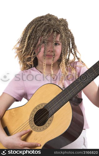 Pretty ten year old girl with rasta curls playing her guitar