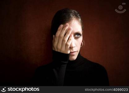 Pretty Woman a Black Turtleneck Covering her Eye