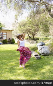 Pretty woman dancing flamenco in the garden of the house