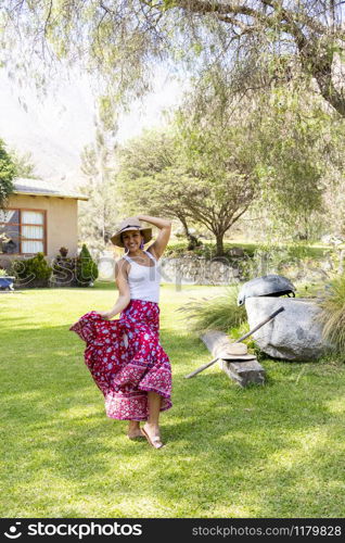 Pretty woman dancing flamenco in the garden of the house