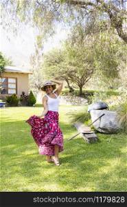 Pretty woman dancing flamenco in the garden of the house