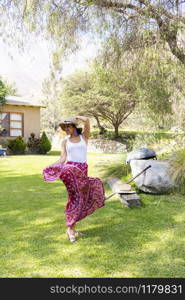 Pretty woman dancing flamenco in the garden of the house