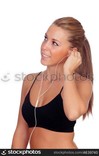 Pretty woman doing fitness istening music with headphones on white background isolated