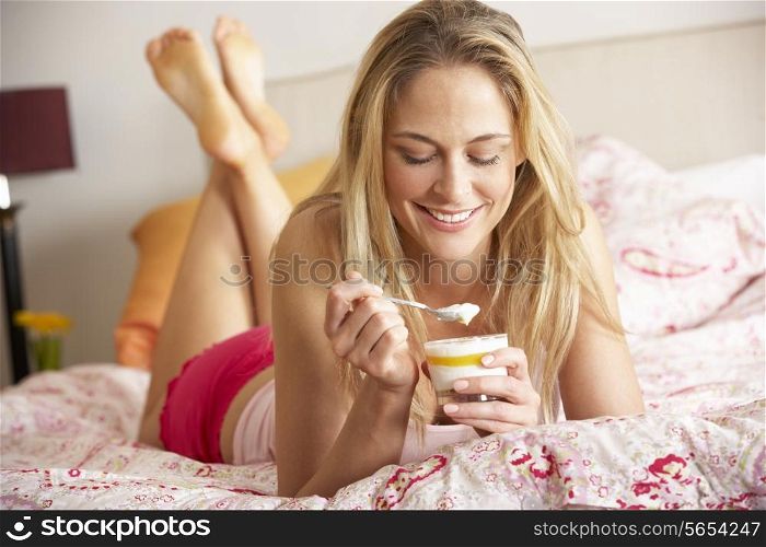 Pretty Woman Eating Dessert In Bed