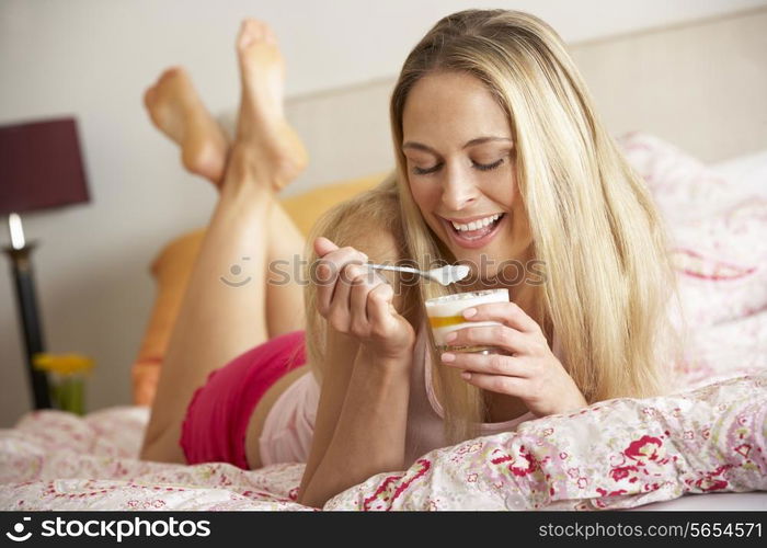 Pretty Woman Eating Dessert In Bed