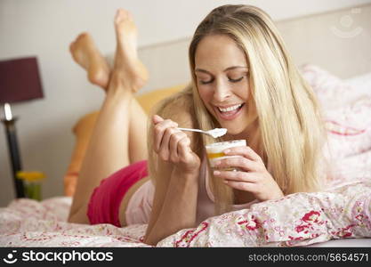 Pretty Woman Eating Dessert In Bed