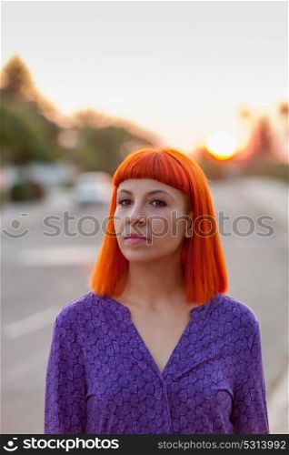 Pretty woman enjoing a beautiful sunset in the street
