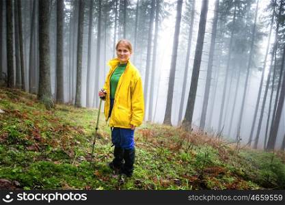 Pretty woman in mistery forest with mist