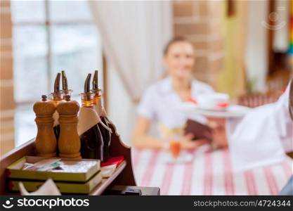 Pretty woman in restaurant. Image of pretty woman sitting at restaurant with menu in hands