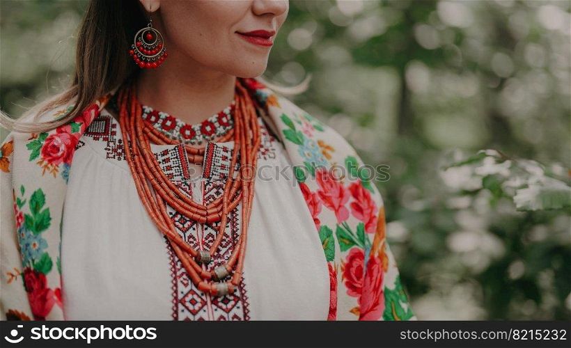Pretty woman in traditional ukrainian jewelry necklace, dress, handkerchief and gerdan. Lady in national costume - vyshyvanka and ancient coral beads on forest nature background. High quality . Pretty woman in traditional ukrainian jewelry necklace, dress, handkerchief and gerdan. Lady in national costume - vyshyvanka and ancient coral beads on forest nature background