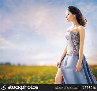 Pretty woman on the summer wheat field
