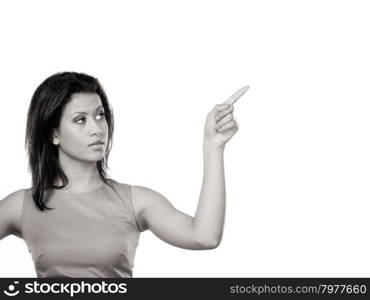 Pretty woman pointing at empty blank copy space.. Portrait of pretty fashion mixed race woman pointing at empty blank copy space. Advertisement. Black and white photo.