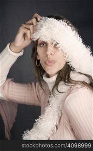 Pretty woman posing with a kiss and a fuzzy scarf
