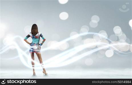 Pretty woman. Rear view of young attractive woman against bokeh background