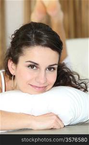 Pretty woman resting on a white pillow