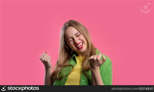 Pretty woman shows triumph yes gesture of victory, she achieved result, goals. Girl glad, happy, surprised excited happy lady on pink background. Jackpot concept. High quality. Pretty woman shows triumph yes gesture of victory, she achieved result, goals