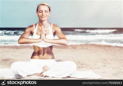 Pretty woman sitting with closed eyes in lotus pose on the beach, meditating on the coast of the sea, enjoying peaceful summer vacation, happy and healthy lifestyle, zen balance