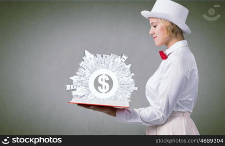 Pretty woman studying book. Young woman in white cylinder and red bowtie with book in hands