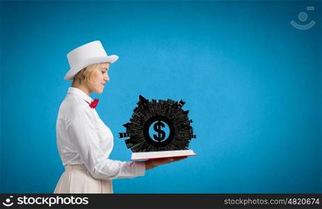 Pretty woman studying book. Young woman in white cylinder and red bowtie with book in hands