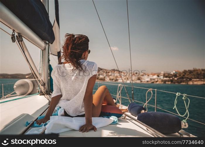 Pretty Woman Tanning on Sailboat. Luxury Summer Trip to Greece. Recreation on Water Transport. Enjoying Vacation on the Yacht.. Enjoying Vacation on Sailboat