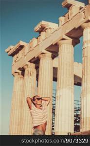 Pretty woman visiting gorgeous touristic place in Athens. Amazing great columns of Parthenon in sunny day. Cute tourist enjoying travel to Europe.. Happy girl tourist visits Acropolis. Greece