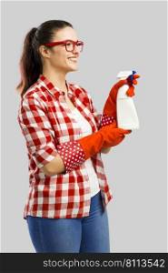 Pretty woman wearing gloves and holding a cleaning spray 
