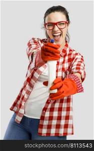 Pretty woman wearing gloves and holding a cleaning spray 