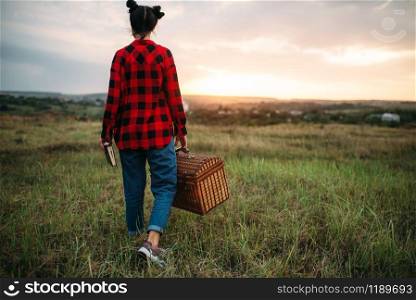 Pretty woman with basket, picnic in summer field. Romantic junket. Pretty woman with basket, picnic in summer field