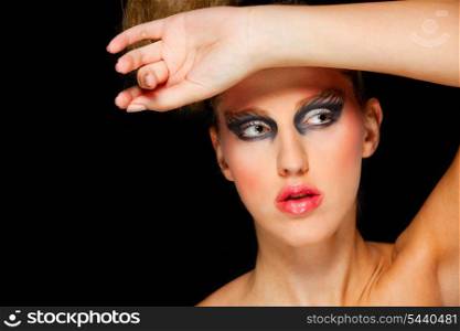 Pretty woman with extravagant make up and hand on head&#xA;