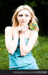 Pretty Woman With Lollipop On The Nature Background