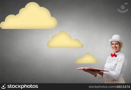 Pretty woman with opened book. Young woman in white cylinder and red bowtie with book in hands