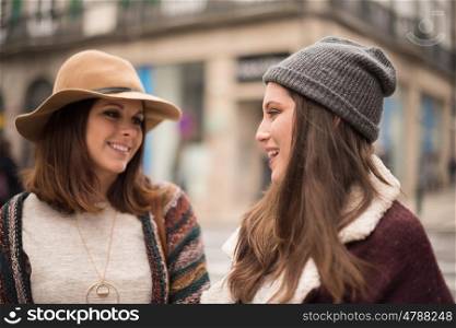 Pretty women wearing winter clothes on the city street