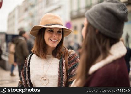 Pretty women wearing winter clothes on the city street