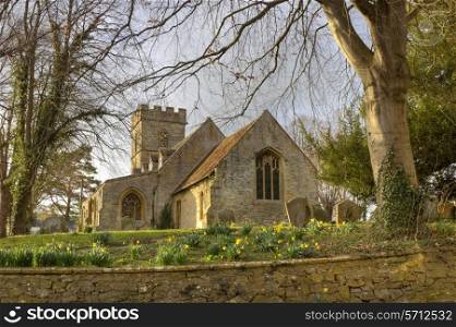 Pretty Worcestershire church with daffodils at springtime, Pebworth, England.