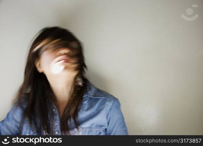 Pretty young Asian woman with swinging head and hair around.