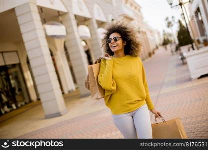 Pretty young black woman with curly hair in shopping